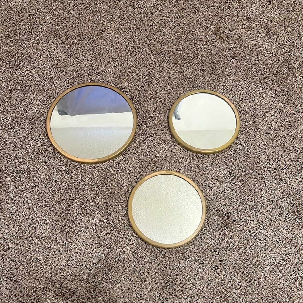 3 gold circle mirrors.